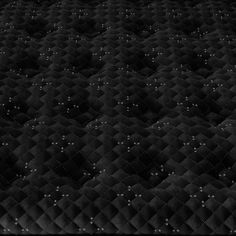 an upholstered mattress is shown in this black and white photo, with small dots on it