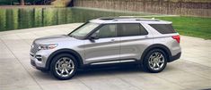 a silver ford explorer parked in front of a lake