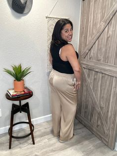 Look like a summer goddess in these flowy taupe satin pants, featuring a luxe elastic waist for the perfect fit — no worries about the waistband digging in, just all-out comfort. Twirl your way through the day in style and grace! (Trust us, you won't regret it.) Summer Goddess, Lay Low, Nude Bra, Satin Pants, Chic Shop, On The Dance Floor, Pants Large, Style And Grace, Black Tank