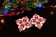 two red and white christmas coasters sitting on top of a table