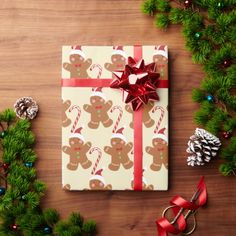 a present wrapped in pink paper and tied with red ribbon, surrounded by christmas decorations