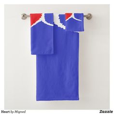 two towels hanging on a towel rack in front of a white wall with red and blue accents