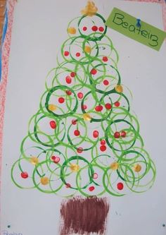 a child's drawing of a christmas tree with circles and berries on the bottom