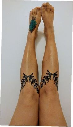 the legs are decorated with tattoos and flowers