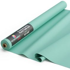 a roll of green colored paper on a white background