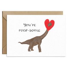 a card with an image of a dinosaur holding a heart