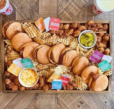 a box filled with lots of different types of food on top of a wooden table