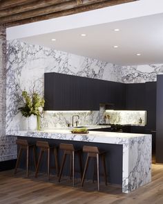 a kitchen with marble counter tops and stools next to an island in the middle