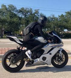 a man riding on the back of a white motorcycle