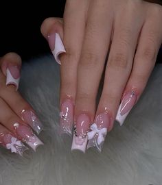 Put a bow on it! Do you want a new nail set? Are you craving more of a coquette feeling that just screams girl. This is such a pretty set perfect for a soft aesthetic. With a clear base and top on the pointer and ring finger with designs on both but a bow on the ring fingers. Theres a pink french tip with an outline of crystals and a flower in the middle on the middle finger and a normal Future Nails, Pink French Tip, Long Nail Designs, Girly Acrylic Nails, French Tip Acrylic Nails, Cute Acrylic Nail Designs, Pink French, French Acrylic Nails, New Nail