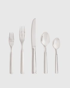 four forks, two spoons and one knife on a white surface