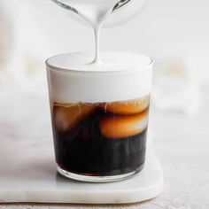 a cup filled with liquid sitting on top of a table