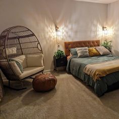 a bed room with a neatly made bed and a birdcage on the wall