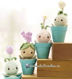 some crocheted potted plants sitting on top of each other