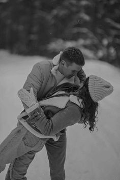 a man and woman kissing in the snow