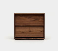 a wooden shelf with two drawers on one side and an open drawer on the other