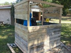 a small wooden structure sitting in the middle of a yard