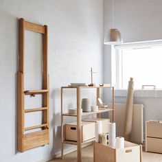 an empty room with boxes and shelves on the floor