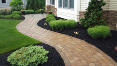 a brick walkway in front of a house