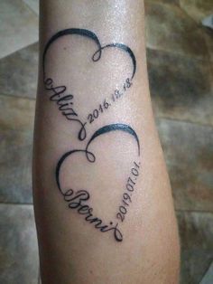 a tattoo with two hearts and the words, love is in the air on it