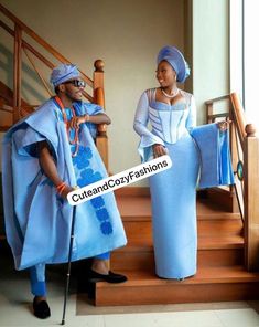 two people dressed in costumes standing on the stairs and one is holding a sign that says culture cross fashions