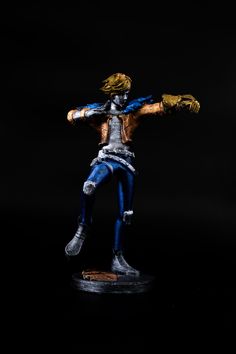 an action figure is posed on a black background