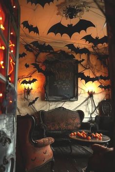 a living room with bats on the wall and pumpkins on the table in front of it