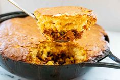 a piece of cake being lifted from a skillet