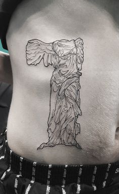 the back of a woman's stomach with an angel tattoo on her lower back