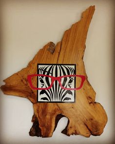 a piece of wood that has some glasses on it and a zebra print in the middle