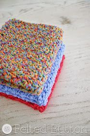 two crocheted dishcloths on top of each other sitting on a table