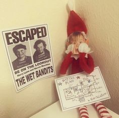 an elf is sitting on the toilet with his hands in his mouth and there are posters behind him