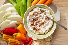 an assortment of vegetables including carrots, celery, and hummus on a plate