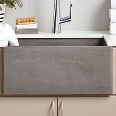 a kitchen sink that is made out of concrete