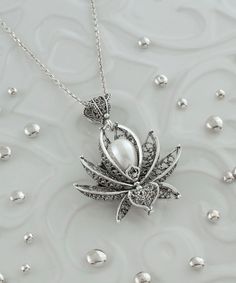 "This 925 Sterling Silver handcrafted filigree art, natural freshwater pearl gemstone lotus flower pendant necklace comes with 20\" silver chain option. Beautifully crafted filigree details will catch all eyes on you. It is going to be an exact match to your daily wear. It can also be the perfect option for valentine`s day, mother`s day or a birthday gift for yourself or your loved one.  The pendant height is 1.65\" / 42.00 mm and the width is 1.35\" / 33.00 mm. The optional sterling silver chain is 18.00\"+2.00\" / 50 cm with extension and spring close closure. It is oxidized and highly polished. The pendant is coming with a free silver polish cloth, velvet pouch, and luxurious gift box.   What is Filigree Art? Filigree is made of delicate metal strands that have been skillfully fashioned Silver Flower Jewelry With Pearl Pendant, Silver Flower-shaped Jewelry With Pearl Pendant, Silver Flower-shaped Necklace With Pearl Pendant, Lotus Jewelry, Lotus Pendant, Flower Charm Necklace, Filigree Necklaces, Flower Choker, Choker Pendant