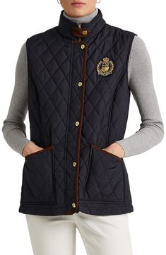 A diamond-quilted vest is accented with a signature LRL crest at the chest for a standout choice in dressing for transitional weather this season. 26" length (size Medium) Stand collar Lined, with 100% polyester fill 100% polyester Dry clean or machine wash, tumble dry Imported Quilted Sleeveless Workwear Vest, Navy Sleeveless Vest For Fall, Quilted Sleeveless Vest For Workwear, Sleeveless Cotton Vest With Padded Collar, Cotton Sleeveless Vest With Padded Collar, Cotton Vest With Padded Collar And Sleeveless Design, Quilted Vest For Workwear In Fall, Quilted Vest For Fall Workwear, Ralph Lauren Vest