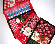 four quilted christmas themed placemats on a white surface