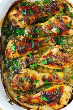 chicken with herbs in a white casserole dish