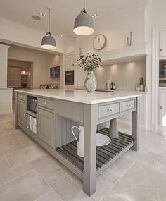 a large kitchen with an island in the middle and lots of counter space on each side