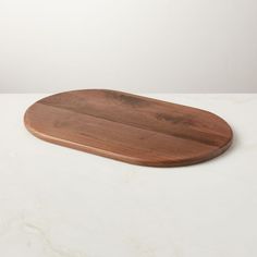 a wooden cutting board sitting on top of a white counter