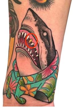 a close up of a person's arm with a tattoo on it and a shark