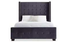 an upholstered bed with white linens and black headboard, on a white background