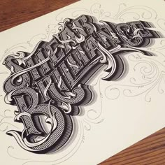 an image of some type of lettering on a piece of paper that is laying on a table