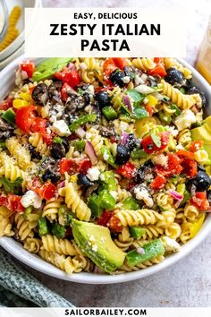 a bowl filled with pasta salad and the words easy, delicious zesty italian pasta