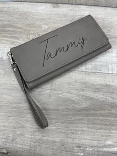 These women's wallets are made from a high quality leatherette and laser engraved (no vinyl stickers or decals here!). It has room for 13 cards (including ID), large open compartment at the back, and a zipping compartment. It snaps shut, and includes a wrist strap. They are just over 7.5 inches wide and 4 inches tall when closed. Since we do our own engraving, we are able to offer a lot of flexibility on what's engraved. We can even add dates if desired (great idea for Bridesmaids' Gifts). Just Wallet With Strap, Wedding Bags, Women's Wallets, Military Gifts, Christmas Gift For Dad, Wedding Bag, Accessories Bags Purses, Gift For Girlfriend, Gift For Wife