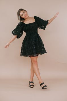 Define elegance in this timeless mini dress. Featuring, an elevating cinched waistline, an elevating floral design throughout, and an ultra feminine short puff sleeve. Such a lovely piece to style throughout the season! Neckline: Square Floral dress Black mini Date Night dress Fabric: 50% Polyester, 50% Rayon; Lining: 80% Rayon, 20% Polyester Short puff style sleeve Cinched elastic waistband Lined Dainty floral design throughout Imported Fit: True to size! Model Specs: Emily is wearing a size sm Short Sleeve Mini Dress With Smocked Bodice For Party, Party Mini Dress With Smocked Bodice And Short Sleeves, Chic Mini Dress With Smocked Bodice And Puff Sleeves, Spring Evening Puff Sleeve Dress With Smocked Bodice, Summer Evening Puff Sleeve Dress With Smocked Bodice, Floral Print Puff Sleeve Mini Dress For Evening, Spring Fit And Flare Mini Dress With Puff Sleeves, Evening Mini Dress With Floral Print And Puff Sleeves, Spring Fit And Flare Puff Sleeve Dress