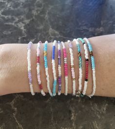 This listing is a collection of 10, dainty minimalistic beaded bracelets! Boho stackable bracelets strung on strong beading string, very durable making them perfect for everyday wear. Wonderful gift for someone or yourself! Each bracelet is sold separately and numbered in pictures 2, 3, and 4 so you can make sure you're getting the right bracelet. Comes in many sizes, and let me know if you don't see yours! All of our jewelry comes gift-wrapped in a little bag, making them the perfect gifts for best friends, gifts for her or to treat yourself! Or would be cute friendship bracelets. They ship very quickly! Spice up your jewelry collection with these beaded bracelets. If you have any questions or anything else feel free to contact me! Seed Beaded bracelets All hand-made by simplyradiantjewel Adjustable Stackable Friendship Bracelets With Round Beads, Handmade Minimalist Beaded Bracelets For Everyday, Stackable Friendship Bracelets With Round Beads, Handmade Minimalist Beaded Bracelets, Adjustable Dainty Heishi Beads Bracelets, Handmade Minimalist Everyday Beaded Bracelets, Trendy Stackable White Friendship Bracelets, Minimalist Handmade Everyday Beaded Bracelets, Trendy White Stackable Friendship Bracelets