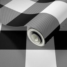 a black and white checkered wallpaper with a roll of tape