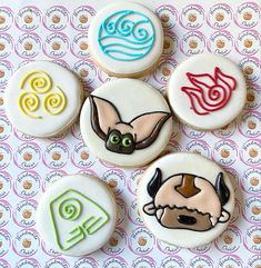 four decorated cookies sitting on top of a table