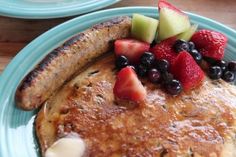 a pancake with fruit on top is sitting on a plate